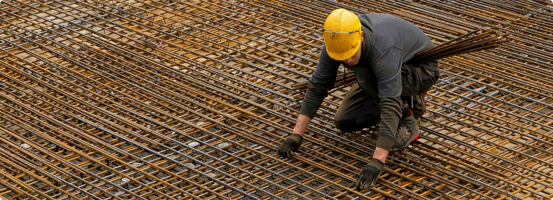 Construction worker erects steel structure