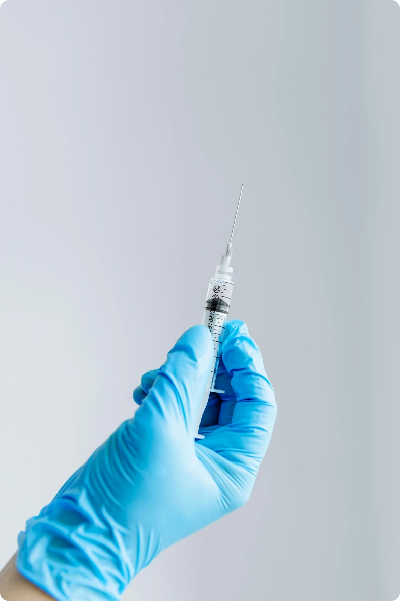 Doctor with glove holding syringe